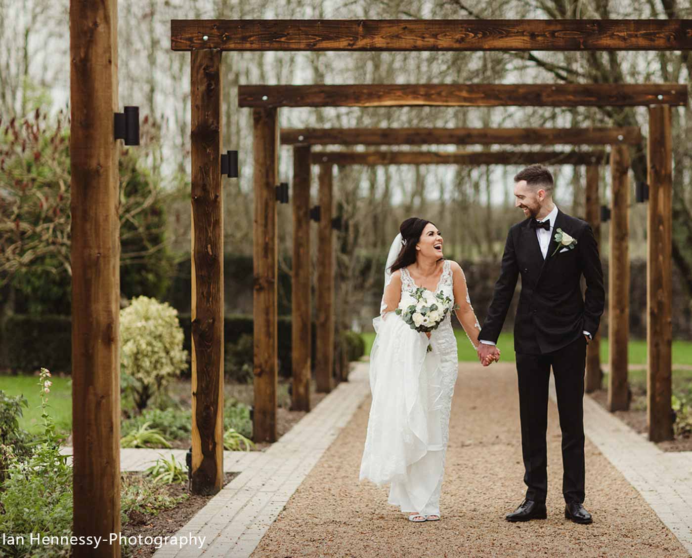 Сouple wearing a white gown and a black suit